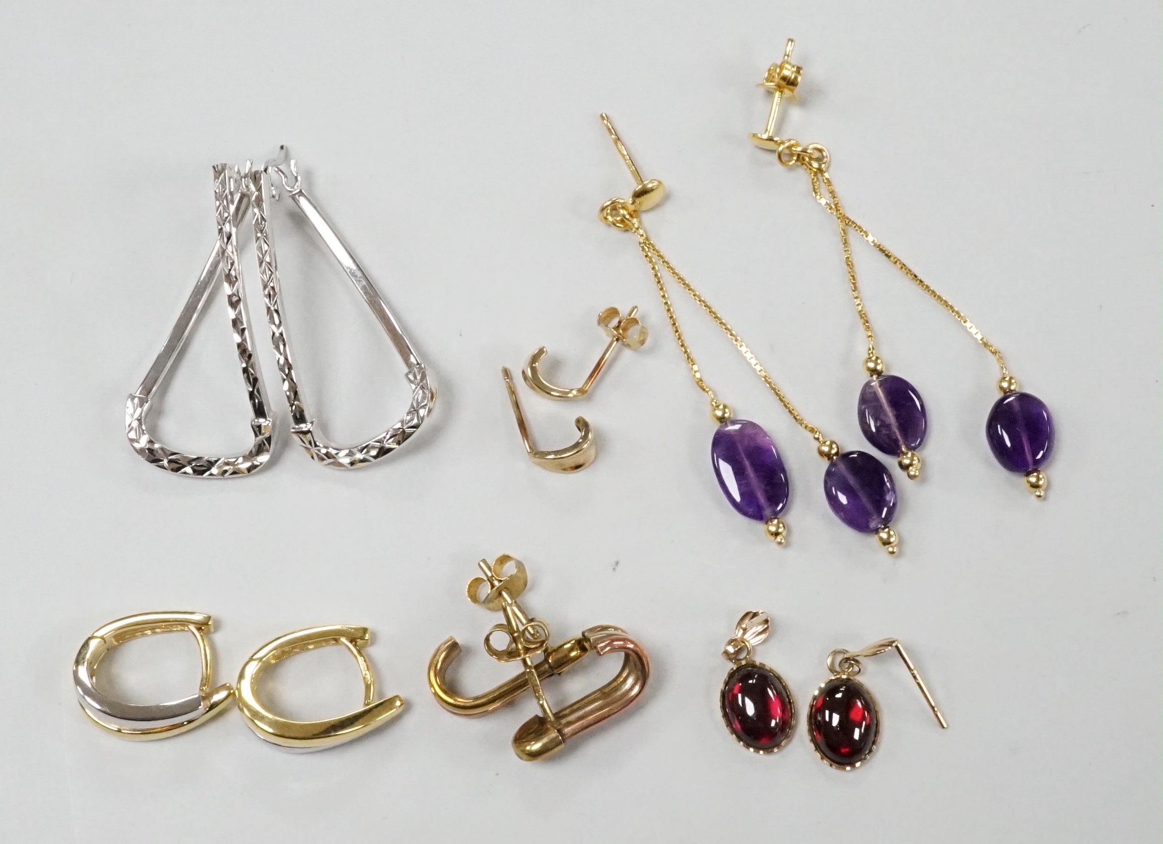 A modern pair of Italian 14k yellow metal and double drop amethyst set earrings, 50mm, gross weight 2.5 grams and five assorted pairs of 375 earrings, including one gem set, gross weight 8.3 grams.